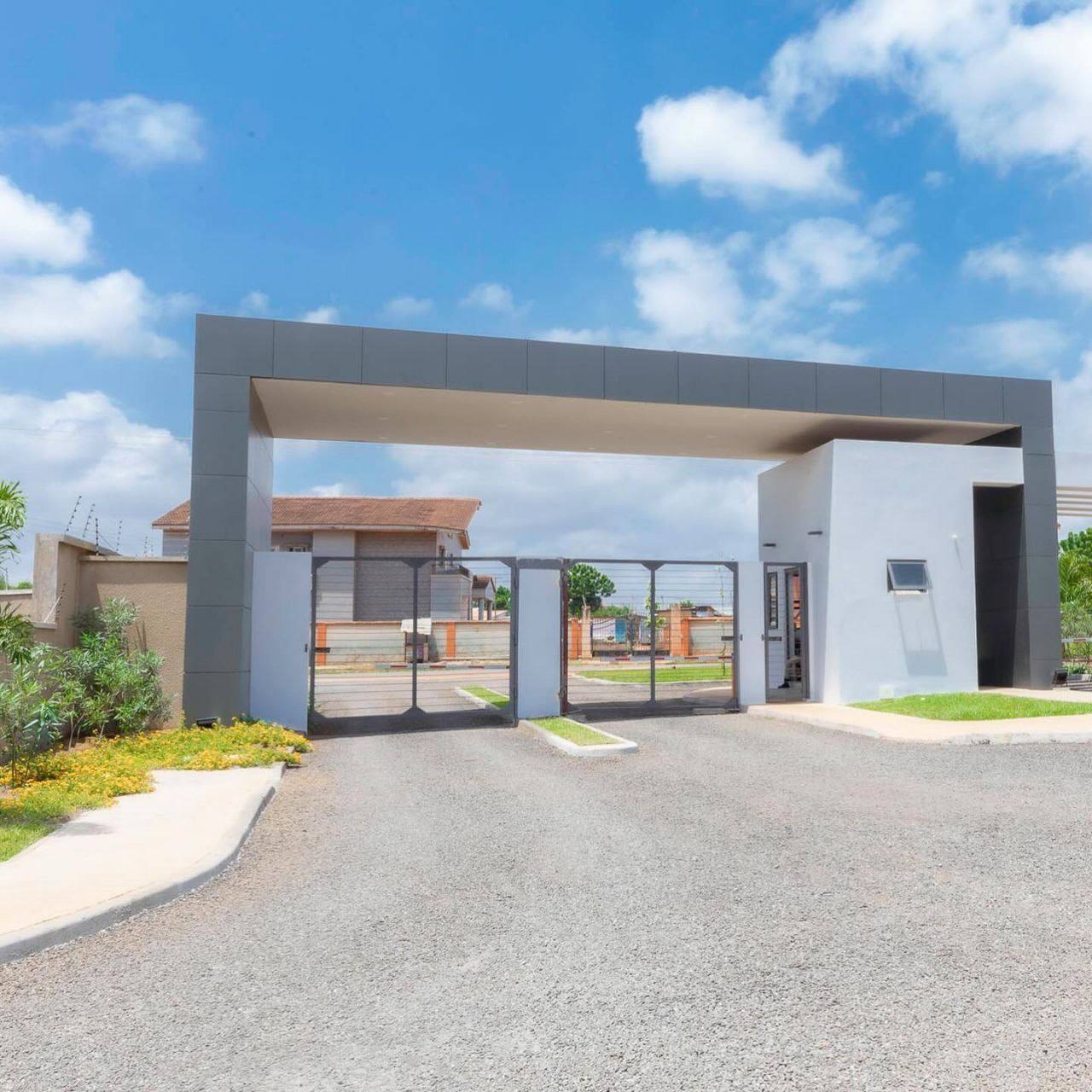 A fence with a large building behind it